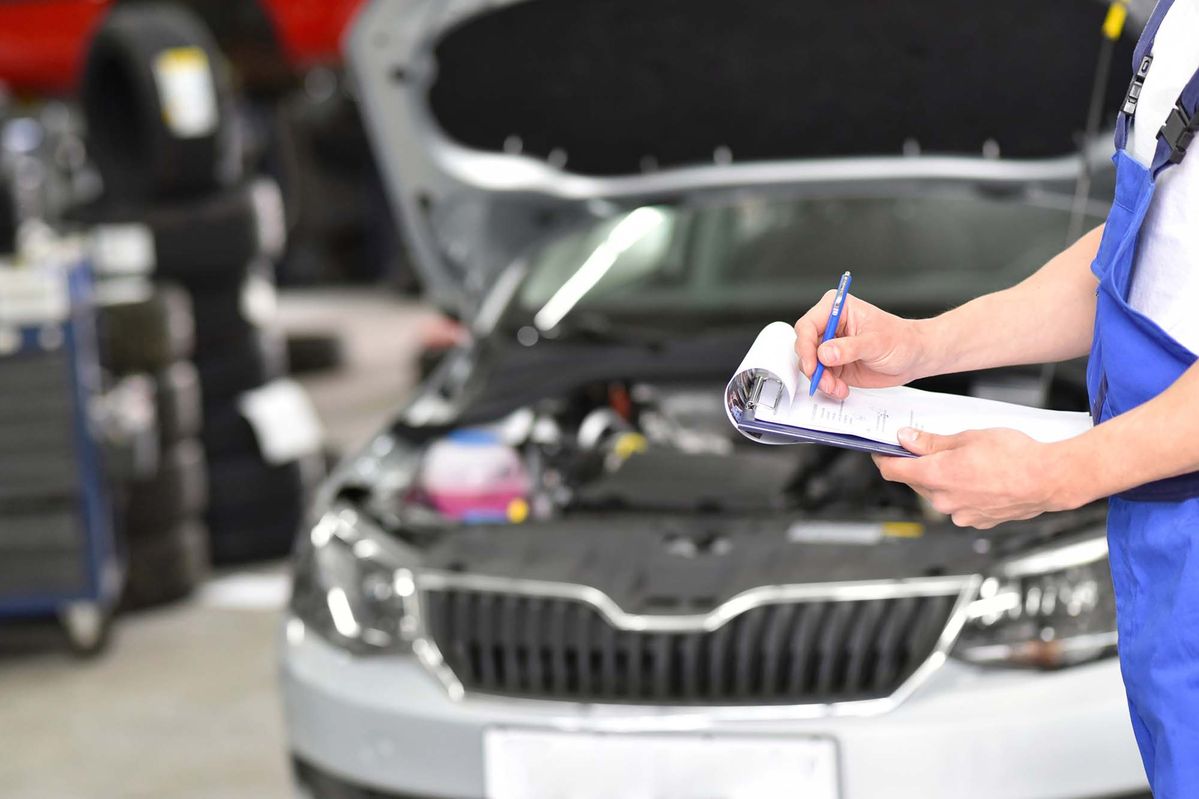 Mechanic performing MOT inspection